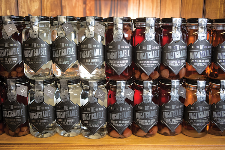 Brad Call serves samples of moonshine to visitors in the tasting room at Call Family Distillers.