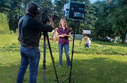 David Dalton, owner of BlueWater Media, films Lisa Prince as she hosts Flavor, NC at an urban garden in Raleigh, N.C.