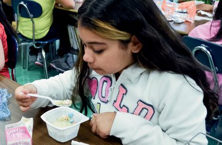 Lafayette Elementary School – fourth grader eating breakfast in the classroom