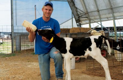Jake Hidebrand bottle feeding a calf