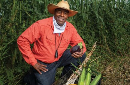 Bruce-Michael Wilson holds vegetables harvested from his organic Groundswell Farm