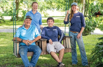 Kim (rear left), Krista (rear right), Dale, and Brendan Erickson on the family farm in Canal Point.