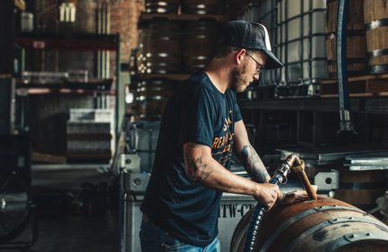 Hotel Tango Distillery employee fills barrel