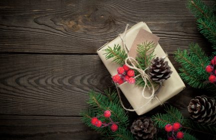 Texas gift guide; Christmas gift box and decorations on wooden table. Top view with copy space