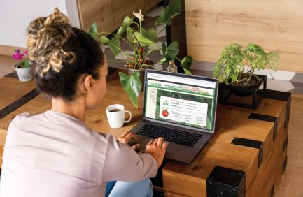 Woman looking at the Virginia Grown website on her laptop