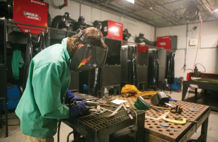 Student works on a piece of equipment in an ag mechanics class at Bristol County Agricultural High School