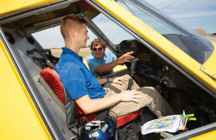 Student Ian McMahen sits in an air tractor as instructor Ike Brunetti shows him the controls at Delta State Universitys Flight School in Cleveland. ©Journal Communications/