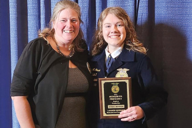 FFA adviser Amanda Sturm with Lauren Gorsuch being awarded the state winner in poultry production