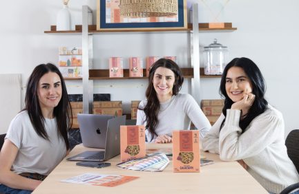Annie, Mollie and Grace pose for a photo at a table with 3 Farm Daughters Pasta