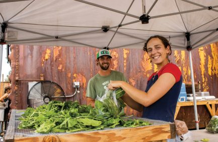 Peyton Foley and Isabel Rosenstein packaging up produce at Mountain Roots Food, both are examples of Colorado food advocates working to bring local foods to everyone