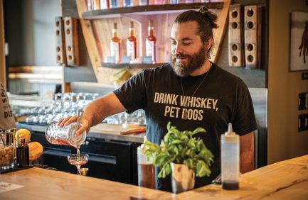 Bartender pours a drink at Spirit Hound Distillers, a local Colorado company