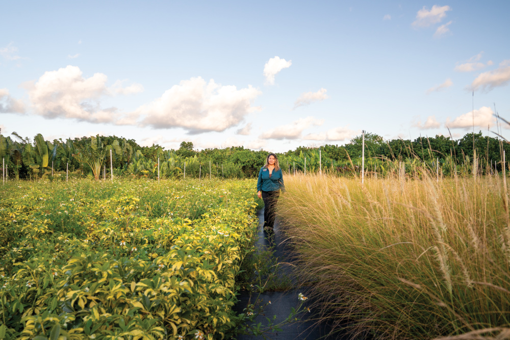 Nancy Garcia of Garcia Nursery walking among plants at her nursery
