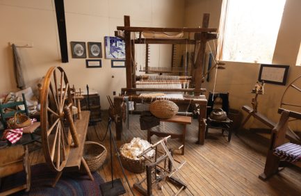 Various historical items on display in the Homespun Hand-Stitched exhibit at the Tennessee Agricultural Museum in Nashville, Tennessee.